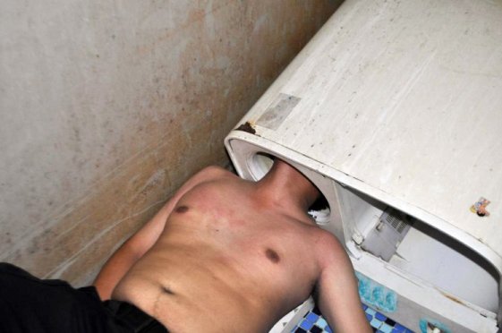 Pic shows: Manís head stuck in the washing machine. A squad of firefighters in China have saved a man from his washing machine after he somehow managed to get his trapped inside the device. Reports said he was inspecting the machineís roller when he stuck his head in and could not get it out again. The unnamed victim from Fuqing, a county-level city in East Chinaís Fujian Province, is said to have been preparing to do his laundry when he turned on the power of the machine but noticed that it was not responding. After pressing a number of different knobs on the machine and getting no response, he thought the roller might have been malfunctioning due to a foreign object being stuck inside. The poor man then decided to stick his head into the cylindrical space to inspect the roller, but was horrified to find himself stuck in the machine. The victim later explained: "I managed to very successfully stick my head into the machine, so I donít understand why I got stuck." The man, shirtless and flushed from trying to escape the washing machine, was found by his flatmate minutes later. The flatmate reportedly tried to free the man by applying soap to his neck, but all attempts were unsuccessful. In the end a team of six firemen arrived to rescue the man by sawing through the plastic roller and eventually pulling it apart. The entire rescue took about 40 minutes, reports said, with the victim suffering minor cuts on his head, but otherwise not in life-threatening condition. (ends)