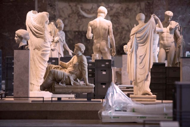 A photo taken on June 3, 2016 shows boxes containing valuable artworks from the Louvre reserves stored among status in one of the museum's room of the Department of Greek, Etruscan, and Roman Antiquities room after they were evacuated from the basement following days of heavy rains which led the River Seine to reach its highest level in three decades. / AFP PHOTO / GEOFFROY VAN DER HASSELT