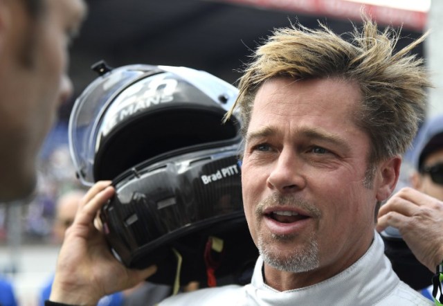 US actor Brad Pitt removes his helmet after a full lap on the Le Mans 24 Hours circuit with a Pescarolo Prototype driven by Austria's Alex Wurz, two-time winner and Grand Marshal for the 84th edition of the Le Mans 24 Hours endurance race, on June 18, 2016 in Le Mans, western France. / AFP PHOTO / JEAN-FRANCOIS MONIER