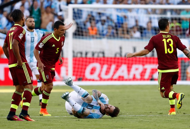 Jun 18, 2016; Foxborough, MA, USA; Argentina midfielder Lionel Messi (10) is spilled by Venezuela midfielder Arquimedes Figuera (5) during the first half of quarter-final play in the 2016 Copa America Centenario soccer tournament at Gillette Stadium. Mandatory Credit: Winslow Townson-USA TODAY Sports