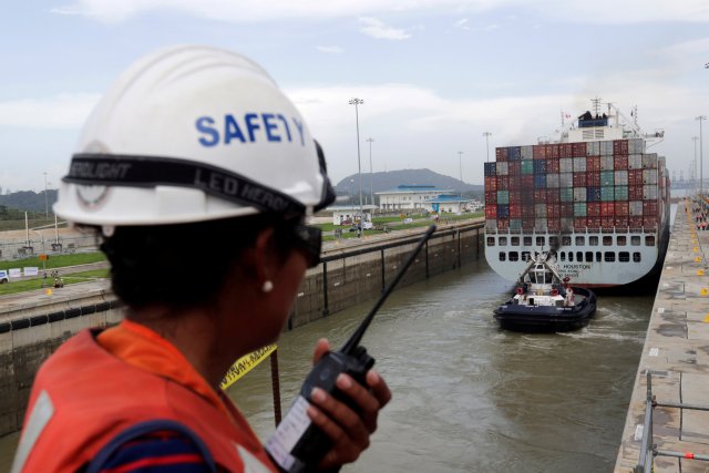 A worker talks on a walkie talkie as cargo ship named Cosco Houston, navigates through Cocoli locks during a test of the new set of locks of the Panama Canal expansion project on the Pacific side in Cocoli, on the outskirts of Panama City, Panama June 23, 2016. REUTERS/Carlos Jasso/File Photo