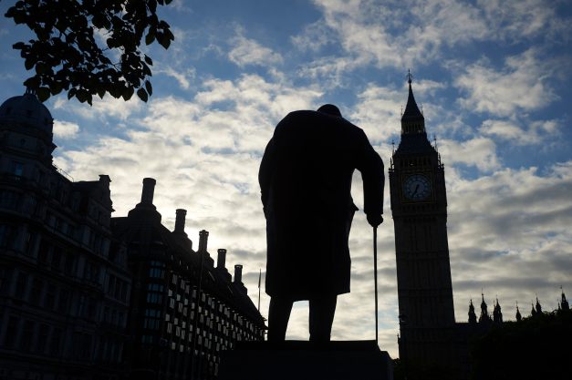 A statue of Winston Churchill is silhouetted by Big Ben and the Houses of Parliament in central London on June 24, 2016. Britain has voted to break out of the European Union, striking a thunderous blow against the bloc and spreading panic through world markets Friday as sterling collapsed to a 31-year low. / AFP PHOTO / Niklas HALLE'N