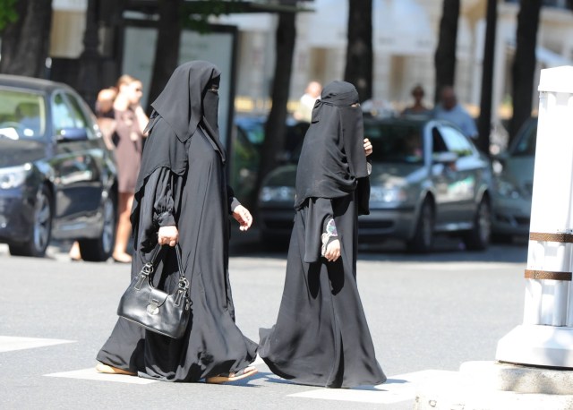 Illustration of women wearing full Islamic veil ( Burka or Niqab ) on Avenue Montaigne in Paris, France on July 7, 2010 as France may ban women from wearing burka in public, a law banning face-covering in public places will be submitted to parliament.