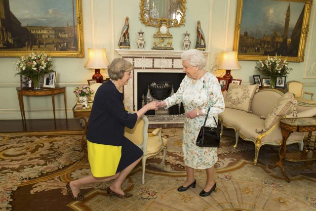 Britain's Queen Elizabeth welcomes Theresa May at the start of an audience in Buckingham Palace, where she invited her to become Prime Minister, in London July 13, 2016. REUTERS/Dominic Lipinski/Pool