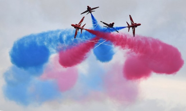Members of the British Royal Air Force Aerobatic Team, the Red Arrows, perform ahead of the British Formula One Grand Prix at Silverstone motor racing circuit in Silverstone, central England, on July 10, 2016. Lewis Hamilton held his nerve to grab pole position ahead of Mercedes team-mate Nico Rosberg for Sunday's British Grand Prix with a spectacular lap in the final seconds of an intense qualifying session. / AFP PHOTO / BEN STANSALL
