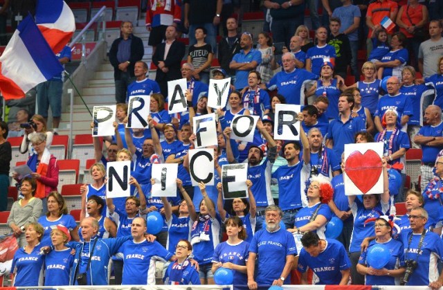 Fans of the French Davis Cup team observe a minute of silence for the victims of the terror attack in Nice during the International Tennis Federation Davis Cup quarter-final opening ceremony on July 15, 2016 in Trinec, Czech Republic. / AFP PHOTO / Michal Cizek