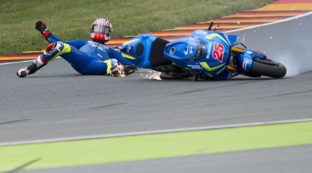 Suzuki rider Maverick Vinales of Spain falls during the second training session of the Moto GP of the Grand Prix of Germany at the Sachsenring Circuit on July 15, 2016 in Hohenstein-Ernstthal, eastern Germany. / AFP PHOTO / Robert MICHAEL