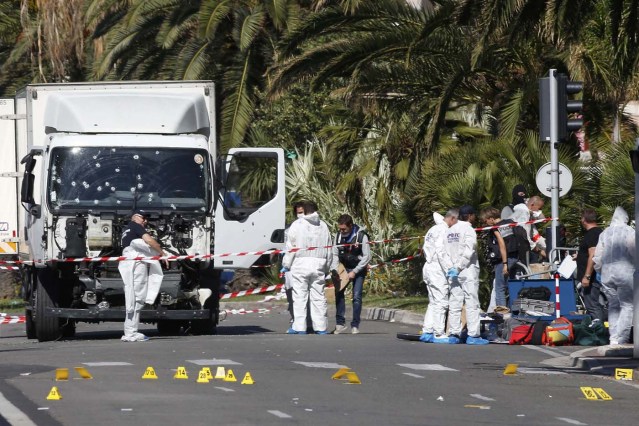 Investigators continue at the scene near the heavy truck that ran into a crowd at high speed killing scores who were celebrating the Bastille Day July 14 national holiday on the Promenade des Anglais in Nice, France, July 15, 2016.    REUTERS/Eric Gaillard