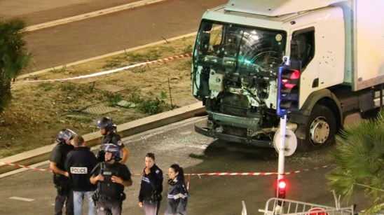 Police investigate the scene after a truck plowed through Bastille Day revelers in the French resort city of Nice, France, Thursday, July 14, 2016. France was ravaged by its third attack in two years when a large white truck mowed through revelers gathered for Bastille Day fireworks in Nice, killing at dozens of people as it bore down on the crowd for more than a mile along the Riviera city's famed seaside promenade. (Sasha Goldsmith via AP)