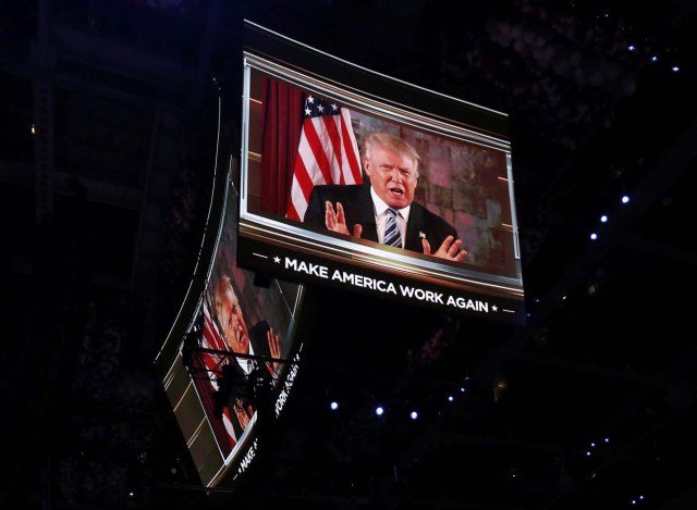 U.S. Republican Presidential Nominee Donald Trump is shown on video monitors as he speaks live to the crowd from New York at the Republican National Convention in Cleveland, Ohio, U.S. July 19, 2016.   REUTERS/Mario Anzuoni