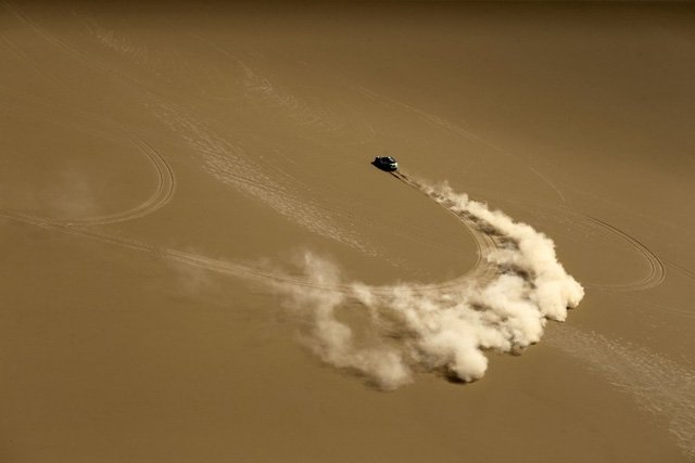 Mini Sport team driver Yazeed Mohamed al-Rahji and co-driver Timo Gottshalk compete in the Gobi Desert on July 18, 2016 during the 9th special stage of the Silkway Rally. One hundred-thirty competitors are racing 10,734 kms, passing three countries and two continents from Moscow to Beijing. / AFP PHOTO / PATRICK BAZ