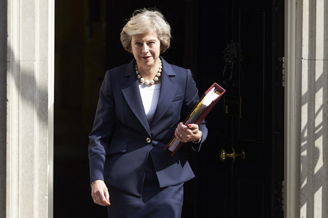British Prime Minister Theresa May leaves 10 Downing street in London on July 20, 2016 on her way to the House of Commons to face her first session of Prime Ministers Questions.  British Prime Minister Theresa May meets European leaders for later today to start thrashing out the roadmap for her country's exit from the European Union. / AFP PHOTO / NIKLAS HALLE'N