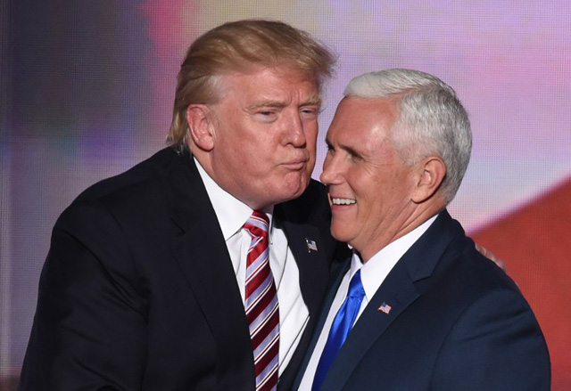 US Republican presidential candidate Donald Trump greets vice presidential candidate Mike Pence after his speech on day three of the Republican National Convention at the Quicken Loans Arena in Cleveland, Ohio, on July 20, 2016. / AFP PHOTO / TIMOTHY A. CLARY