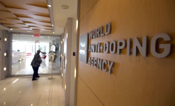 A woman walks into the head office for the World Anti-Doping Agency (WADA) in Montreal, November 9, 2015. An international anti-doping commission recommended on Monday that Russia's Athletics Federation be banned from international competition over widespread doping offences - a move that could see the powerhouse Russian team excluded from next year's Rio Olympics. Russian sports minister said there was no evidence for the accusations against the Federation. REUTERS/Christinne Muschi TPX IMAGES OF THE DAY