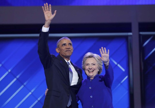 U.S. President Barack Obama and Democratic presidential nominee Hillary Clinton appear onstage together after his speech on the third night at the Democratic National Convention in Philadelphia, Pennsylvania, U.S. July 27, 2016. REUTERS/Mark Kauzlarich