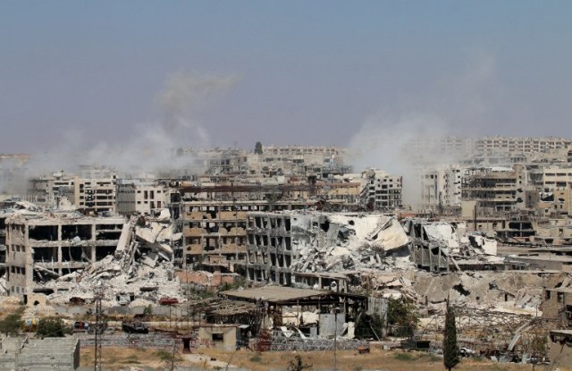 Smoke billows from buildings during an operation by Syrian government forces to retake control of the rebel-held district of Leramun, on the northwest outskirts of Aleppo, on July 26, 2016. The Syrian Observatory for Human Rights said on July 26 loyalist troops had full control of the Leramun district after heavy clashes, and reported fighting for neighbouring Bani Zeid, which is also held by rebels. / AFP PHOTO / GEORGE OURFALIAN