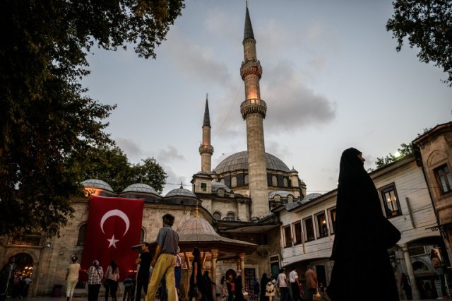 A Turkish national flag is seen on Eyup sultan mosque on July 26, 2016 in Eyup district in Istanbul, following the failed military coup attempt of July 15. Two Turkish generals serving in Afghanistan have been detained in Dubai on suspicion of links to the July 15 failed coup against President Recep Tayyip Erdogan, a Turkish official said on July 26. / AFP PHOTO / OZAN KOSE