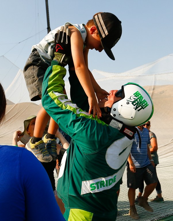 SIMI VALLEY, CA - JULY 30: Skydiver Luke Aikins celebrates with son Logan after jumping 25,000 feet from an airplane without a parachute or wing suit as part of 'Stride Gum Presets Heaven Sent' on July 30, 2016 in Simi Valley, California. Mark Davis/Getty Images for Stride Gum/AFP