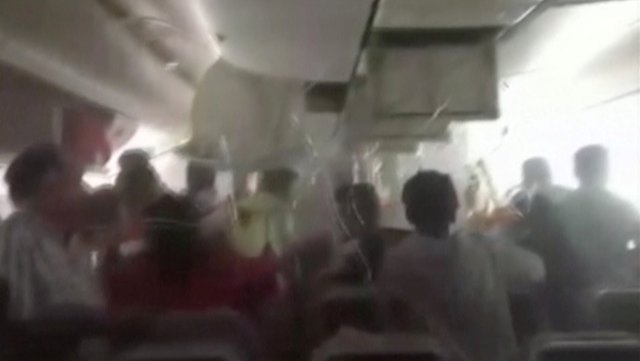 A still image from video shows passengers in an Emirates Airline airplane trying to access oxygen masks, after the plane crash-landed and seconds before the fuselage was engulfed in a ball of flame, in Dubai International Airport, United Arab Emirates August 3, 2016. Video taken August 3, 2016.   Handout via REUTERS TV   ATTENTION EDITORS - THIS PICTURE WAS PROVIDED BY A THIRD PARTY. FOR EDITORIAL USE ONLY. NO RESALES. NO ARCHIVE.