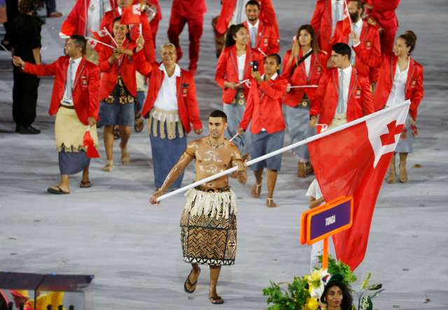 2016 Rio Olympics - Opening ceremony - Maracana - Rio de Janeiro, Brazil - 05/08/2016. Flagbearer Pita Nikolas Taufatofua (TGA) of Tonga leads his contingent during the athletes' parade at the opening ceremony. REUTERS/Stoyan Nenov TPX IMAGES OF THE DAY FOR EDITORIAL USE ONLY. NOT FOR SALE FOR MARKETING OR ADVERTISING CAMPAIGNS.