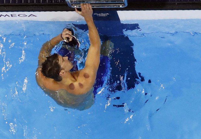 2016 Rio Olympics - Swimming - Final - Men's 200m Butterfly Semifinals - Olympic Aquatics Stadium - Rio de Janeiro, Brazil - 08/08/2016. Michael Phelps (USA) of USA reacts after finishing second. Picture rotated 180 degrees. REUTERS/Athit Perawongmetha FOR EDITORIAL USE ONLY. NOT FOR SALE FOR MARKETING OR ADVERTISING CAMPAIGNS.