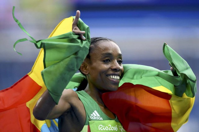 2016 Rio Olympics - Athletics - Final - Women's 10,000m Final - Olympic Stadium - Rio de Janeiro, Brazil - 12/08/2016. Almaz Ayana (ETH) celebrates    REUTERS/Dylan Martinez  FOR EDITORIAL USE ONLY. NOT FOR SALE FOR MARKETING OR ADVERTISING CAMPAIGNS.