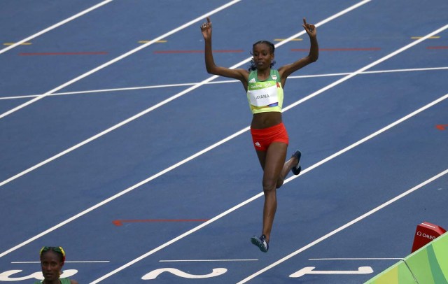 2016 Rio Olympics - Athletics - Final - Women's 10,000m Final - Olympic Stadium - Rio de Janeiro, Brazil - 12/08/2016.  Almaz Ayana (ETH) of Ethiopia celebrates as she wins the gold.  REUTERS/Ivan Alvarado  FOR EDITORIAL USE ONLY. NOT FOR SALE FOR MARKETING OR ADVERTISING CAMPAIGNS.