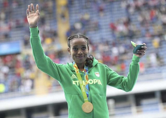 2016 Rio Olympics - Athletics - Victory Ceremony - Women's 10,000m Victory Ceremony - Olympic Stadium - Rio de Janeiro, Brazil - 12/08/2016.    Gold medallist Almaz Ayana (ETH) of Ethiopia poses with her medal.  REUTERS/Alessandro Bianchi FOR EDITORIAL USE ONLY. NOT FOR SALE FOR MARKETING OR ADVERTISING CAMPAIGNS.