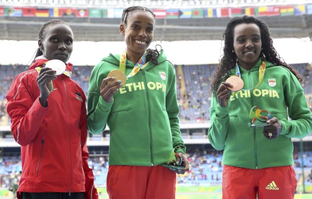 2016 Rio Olympics - Athletics - Victory Ceremony - Women's 10,000m Victory Ceremony - Olympic Stadium - Rio de Janeiro, Brazil - 12/08/2016.    Gold medallist Almaz Ayana (ETH) of Ethiopia, silver medallist Vivian Jepkemoi Cheruiyot (KEN) of Kenya and bronze medallist Tirunesh Dibaba (ETH) of Ethiopia pose with their medals.  REUTERS/Alessandro Bianchi FOR EDITORIAL USE ONLY. NOT FOR SALE FOR MARKETING OR ADVERTISING CAMPAIGNS.