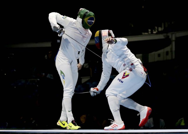 2016 Rio Olympics - Fencing - Preliminary - Men's Epee Team Table of 16 - Carioca Arena 3 - Rio de Janeiro, Brazil - 14/08/2016. Guilherme Melaragno (BRA) of Brazil competes with Silvio Fernandez (VEN) of Venezuela. REUTERS/Issei Kato FOR EDITORIAL USE ONLY. NOT FOR SALE FOR MARKETING OR ADVERTISING CAMPAIGNS.