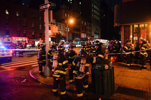 New York City firefighters stand near the site of an explosion in the Chelsea neighborhood of Manhattan, New York, U.S. September 17, 2016. REUTERS/Rashid Umar Abbasi