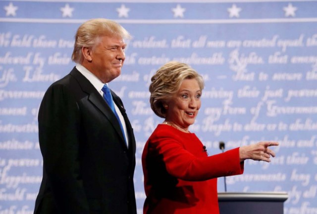 Republican U.S. presidential nominee Donald Trump and Democratic U.S. presidential nominee Hillary Clinton look on at the start of their first presidential debate at Hofstra University in Hempstead, New York, U.S., September 26, 2016. REUTERS/Brian Snyder