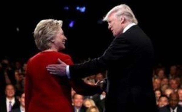 Donald Trump shakes hands with Hillary Clinton. REUTERS/Joe Raedle/Pool