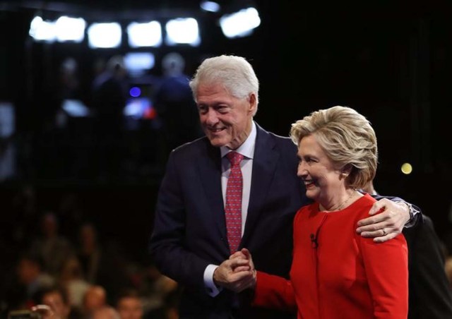 Democratic U.S. presidential nominee Hillary Clinton holds hands with her husband, former President Bill Clinton, as they leave the stage after the conclusion of the first debate with Republican U.S. presidential nominee Donald Trump at Hofstra University in Hempstead, New York, U.S., September 26, 2016. REUTERS/Joe Raedle/Pool