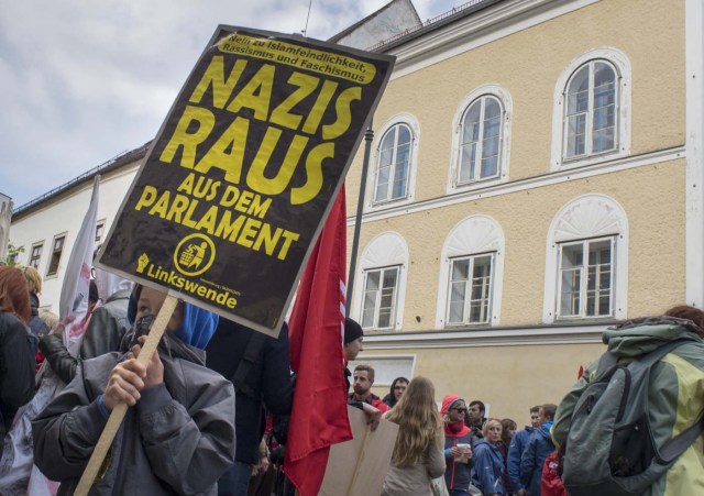 (FILES) This file photo taken on April 18, 2015 shows protesters gathering outside the house where Adolf Hitler was born during the anti-Nazi protest in Braunau Am Inn, Austria. The house in Austria where Adolf Hitler was born is to be torn down to stop it from becoming a neo-Nazi shrine, authorities said on October 17, 2016 after years of bitter legal wrangling. / AFP PHOTO / JOE KLAMAR