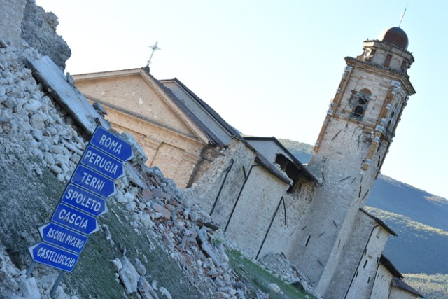 A wall has collapsed due to a 6.6 magnitude earthquake on October 30, 2016 in Norcia. It came four days after quakes of 5.5 and 6.1 magnitude hit the same area and nine weeks after nearly 300 people died in an August 24 quake that devastated the tourist town of Amatrice at the peak of the holiday season. Italy's most powerful earthquake in 36 years dealt a new blow Sunday to the country's seismically vulnerable heart, sending terrified residents fleeing for the third time in nine weeks and flattening a revered six-century-old church. / AFP PHOTO / ALBERTO PIZZOLI
