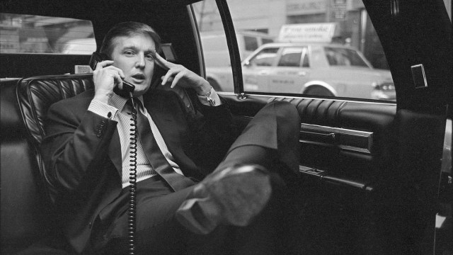 Donald Trump on the phone in his car after announcing plans for development of the west side of midtown Manhattan at the Hyatt Hotel on 42nd Street and Lexington Avenue, in New York, on Nov. 18, 1985.