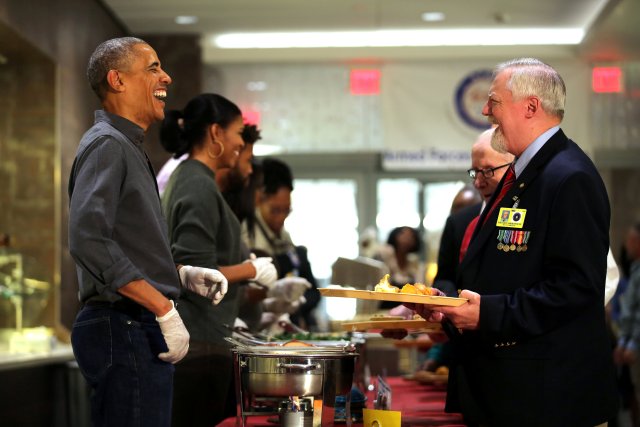 U.S. President Barack Obama and First Lady Michelle Obama serve Thanksgiving dinner to residents of the Armed Forces Retirement Home (AFRH) in Washington, U.S., November 23, 2016. REUTERS/Carlos Barria TPX IMAGES OF THE DAY