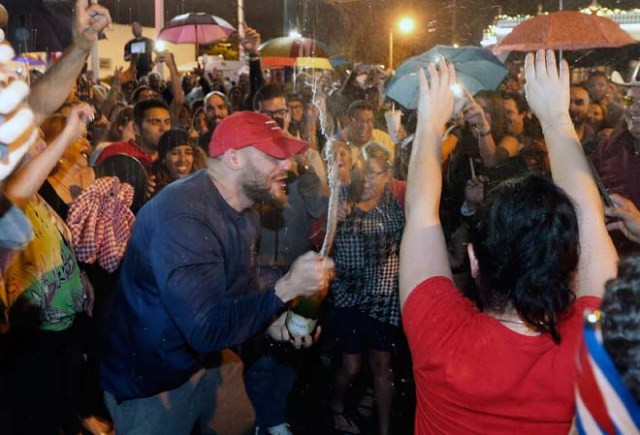 Cuban Americans celebrate upon hearing about the death of longtime Cuban leader Fidel Castro in the Little Havana neighborhood of Miami, Florida on November 26, 2016. Cuba's socialist icon and father of his country's revolution Fidel Castro died on November 25 aged 90, after defying the US during a half-century of ironclad rule and surviving the eclipse of global communism. / AFP PHOTO / RHONA WISE