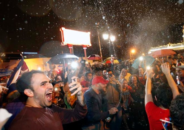 Cuban Americans celebrate upon hearing about the death of longtime Cuban leader Fidel Castro in the Little Havana neighborhood of Miami, Florida on November 26, 2016. Cuba's socialist icon and father of his country's revolution Fidel Castro died on November 25 aged 90, after defying the US during a half-century of ironclad rule and surviving the eclipse of global communism. / AFP PHOTO / RHONA WISE