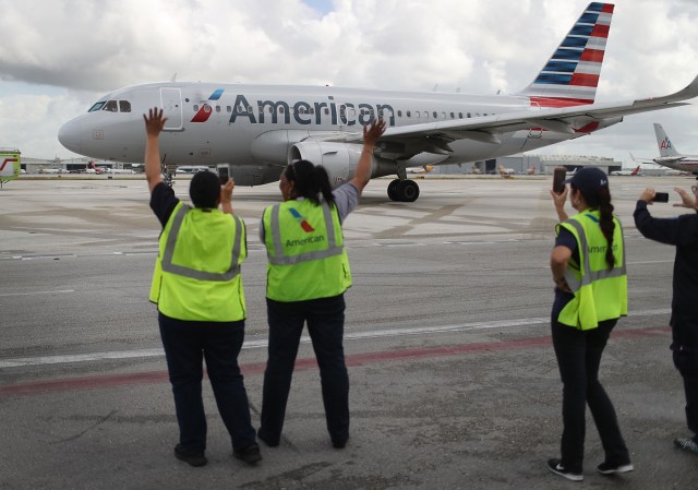 (FILES) This file photo taken on September 7, 2016 shows Employees watching as American Airlines Flight 903 prepares for take off, becoming the first commercial flight from Miami to Cuba in 55 years in Miami, Florida. As Cuba continues to mourn the death of Fidel Castro, the first regular commercial flight between Miami and Havana since the US and Cuba restored diplomatic relations after five decades of Cold War enmity, will depart at 1230 GMT on November 28, 2016, and arrive in Havana an hour later at 1330 GMT. / AFP PHOTO / GETTY IMAGES NORTH AMERICA / JOE RAEDLE