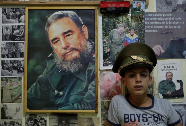 Marlon Mendez (10), who says he is an admirer of Cuba's former president Fidel Castro, poses inside his bedroom that is adorned with pictures of Castro, in Artemisa province, Cuba November 27, 2016. REUTERS/Enrique de la Osa