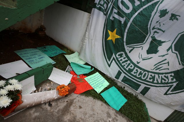 Flowers and messages are seen next a Chapecoense soccer team flag in tribute to their players in front of the Arena Conda stadium in Chapeco, Brazil, November 29, 2016. REUTERS/Paulo Whitaker