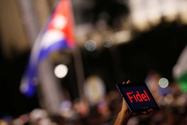 A man holds a tablet during a massive tribute to Cuba's late President Fidel Castro on Revolution Square in Havana, Cuba, November 29, 2016. REUTERS/Stringer EDITORIAL USE ONLY. NO RESALES. NO ARCHIVE