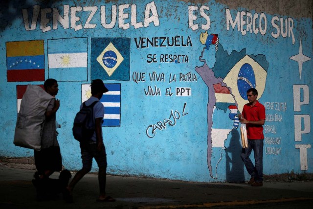 Venezuelan citizens walk past graffiti referencing Mercosul in Caracas, Venezuela, December 1, 2016. REUTERS/Ueslei Marcelino FOR EDITORIAL USE ONLY. NO RESALES. NO ARCHIVES.