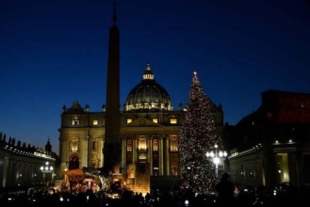 The Christmas tree is pictured at the Saint Peter's square following its illumination on December 9, 2016 in Vatican. This year, the Christmas ornaments were made by children of the paediatric oncology departments of Italian hospitals. / AFP PHOTO / VINCENZO PINTO
