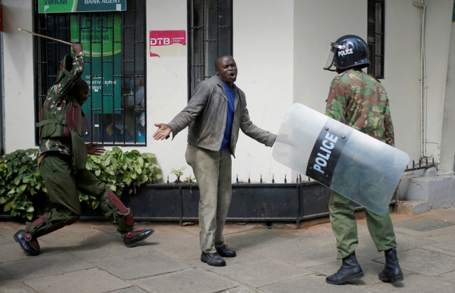 FILE PHOTO - Kenyan policemen beat a protester during clashes in Nairobi, Kenya May 16, 2016. REUTERS/Goran Tomasevic/File Photo REUTERS PICTURES OF THE YEAR 2016 - SEARCH 'POY 2016' TO FIND ALL IMAGES