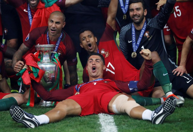 FILE PHOTO - Football Soccer - Portugal v France - EURO 2016 - Final - Stade de France, Saint-Denis near Paris, France - 10/7/16Portugal's Cristiano Ronaldo celebrates with Ricardo Quaresma, Nani, Rui Patricio and the trophy after winning Euro 2016 REUTERS/Carl Recine/Livepic/File Photo REUTERS PICTURES OF THE YEAR 2016 - SEARCH 'POY 2016' TO FIND ALL IMAGES