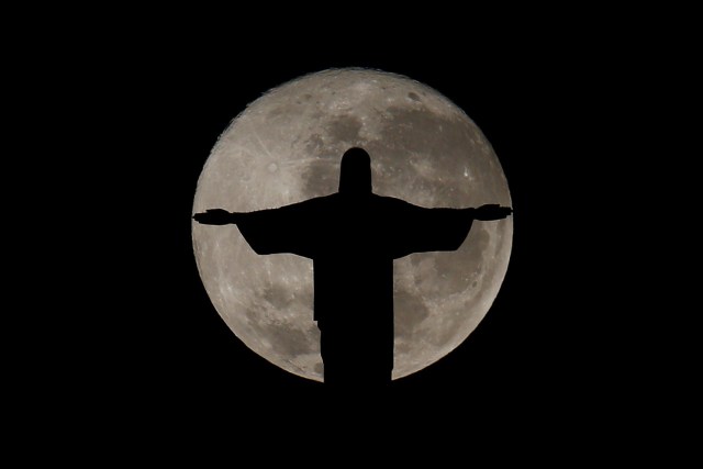 FILE PHOTO - The full moon is pictured behind the Christ the Redeemer statue ahead of the 2016 Rio Olympic games in Rio de Janeiro, Brazil, July 19, 2016. REUTERS/Bruno Kelly/File Photo REUTERS PICTURES OF THE YEAR 2016 - SEARCH 'POY 2016' TO FIND ALL IMAGES