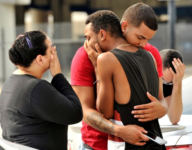 FILE PHOTO - Friends and family members embrace outside the Orlando Police Headquarters during the investigation of a shooting at the Pulse night club, where as many as 20 people have been injured after a gunman opened fire, in Orlando, Florida, June 12, 2016. REUTERS/Steve Nesius/File Photo REUTERS PICTURES OF THE YEAR 2016 - SEARCH 'POY 2016' TO FIND ALL IMAGES